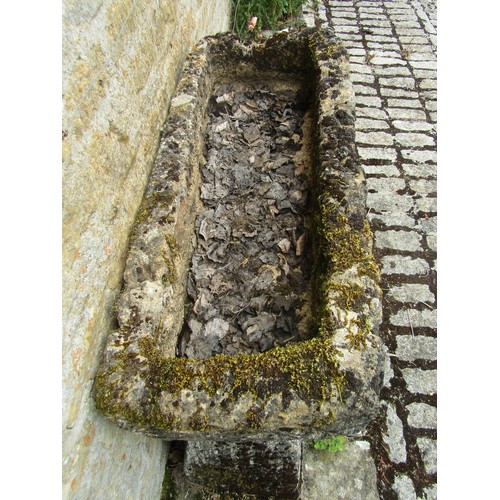 1025 - A weathered and gnarled natural stone planter / trough of rectangular form raised on an associated p... 