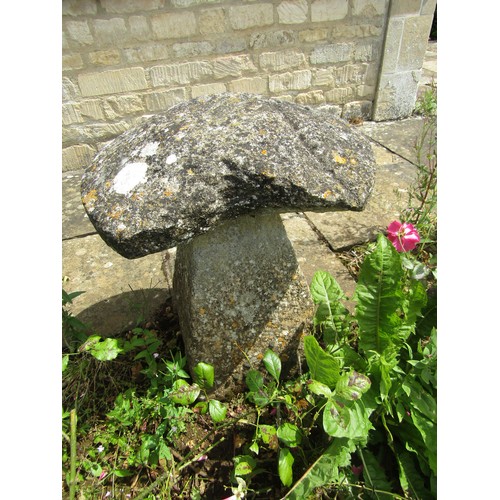 1032 - A weathered natural stone staddle stone and cap, 66cm high, 56cm diameter (with losses to cap) 66cm ... 