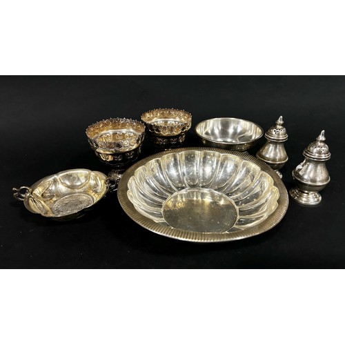 242 - A mixed selection of silver including a pair of pepper pots, a salt cauldron, a shallow scalloped bo... 