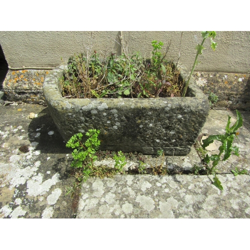 1037 - A weathered natural stone planter / trough of demi-lune form, 26cm high, 56 x 40cm.

From the collec... 