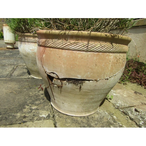 1039 - pair of weathered terracotta planters of tapering form with fluted collars, (one severely damaged) e... 