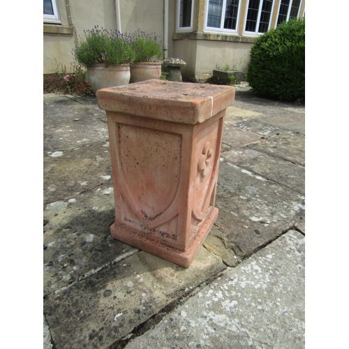 1040 - A modern weathered terracotta plinth with shield motif decoration, 51cm high, 30cm diameter. 

From ... 