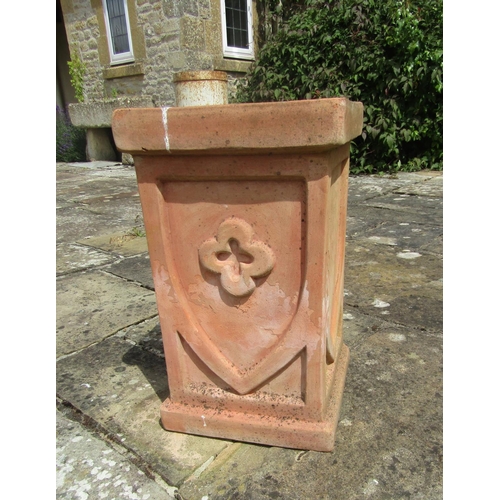 1040 - A modern weathered terracotta plinth with shield motif decoration, 51cm high, 30cm diameter. 

From ... 