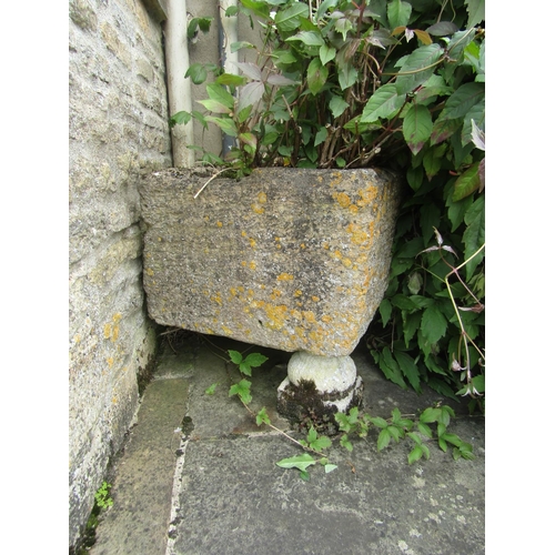 1042 - A weathered natural stone planter / trough of rectangular form, raised on carved limestone soccle su... 