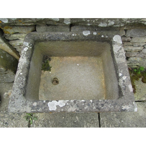 1045 - A weathered natural stone planter / trough of square form raised on associated plinth support, 28cm ... 