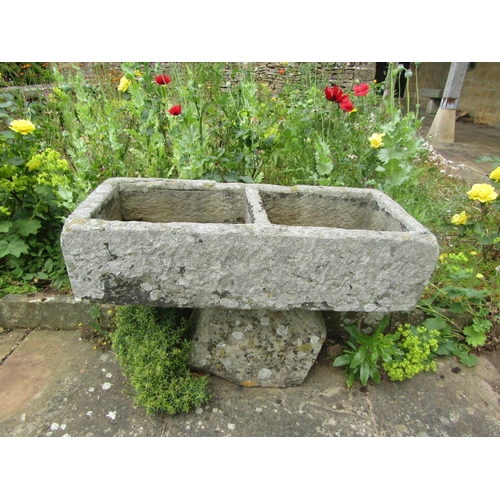 1050 - A weathered natural stone two-sectional stone planter raised on associated rough hewn stone base, 21... 