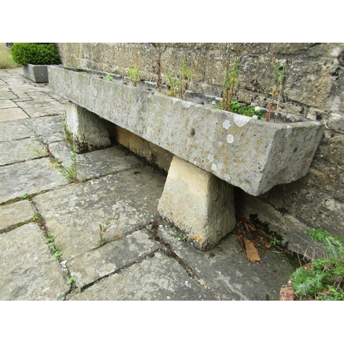 1053 - A long weathered natural stone planter / trough of rectangular form raised on an associated pair of ... 