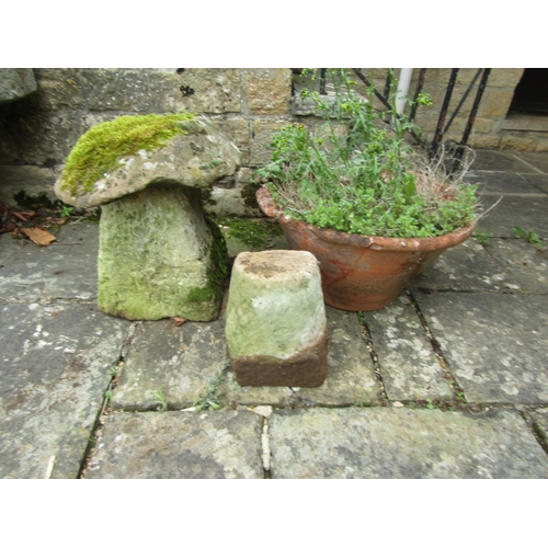 1054 - A small weathered natural stone staddle stone and cap, 50cm high, together with a weathered and rive... 