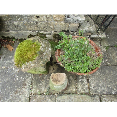 1054 - A small weathered natural stone staddle stone and cap, 50cm high, together with a weathered and rive... 