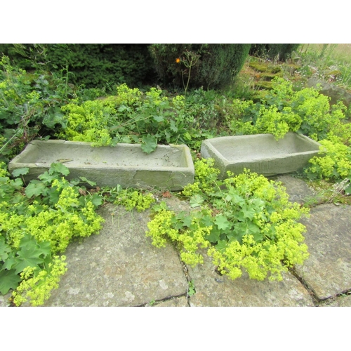 1056 - An associated pair of weathered natural stone planters / troughs of rectangular form (one with some ... 