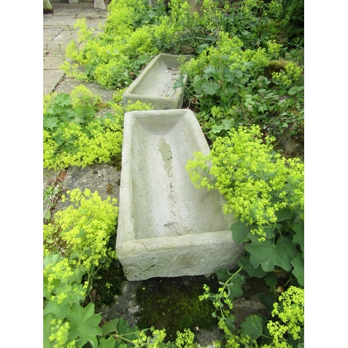 1056 - An associated pair of weathered natural stone planters / troughs of rectangular form (one with some ... 