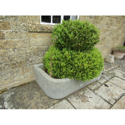 1057 - A large weathered natural stone planter / trough of rectangular form with a rounded edge (with well ... 