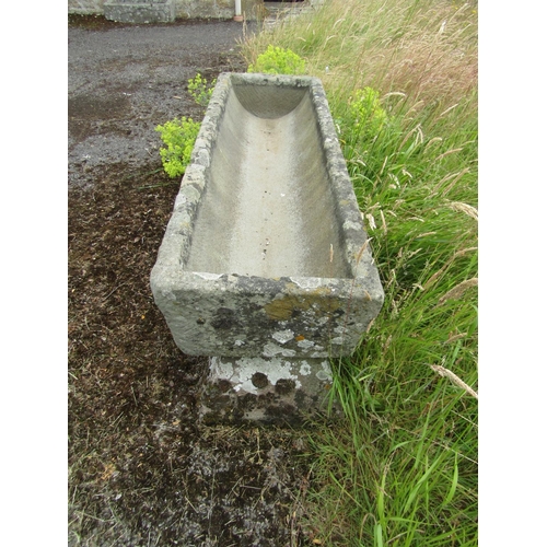 1058 - A weathered natural stone planter / trough of rectangular form raised on an associated pair of trest... 