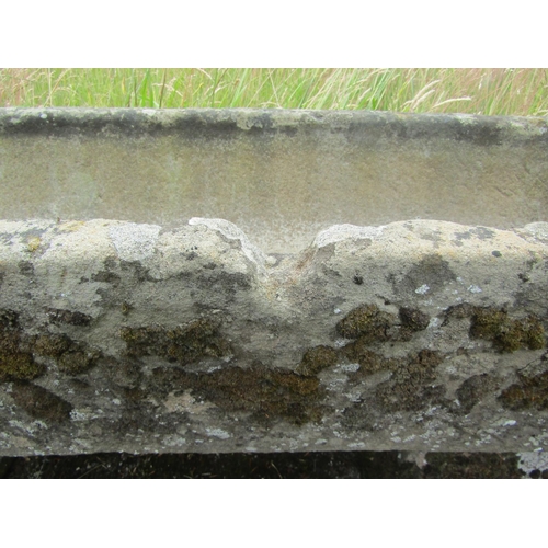 1058 - A weathered natural stone planter / trough of rectangular form raised on an associated pair of trest... 