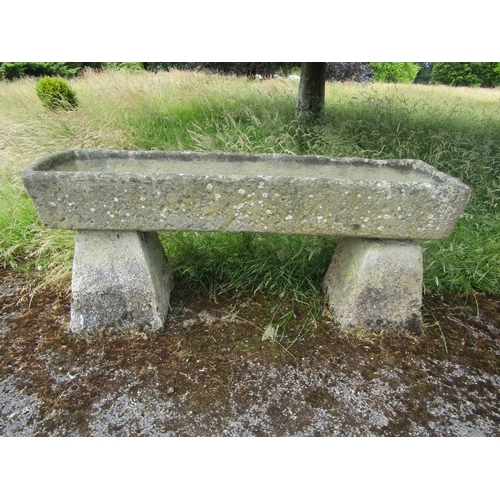 1060 - A large weathered natural stone planter / trough of rectangular form, raised on a pair of associated... 