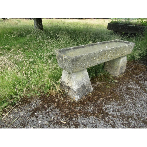 1060 - A large weathered natural stone planter / trough of rectangular form, raised on a pair of associated... 