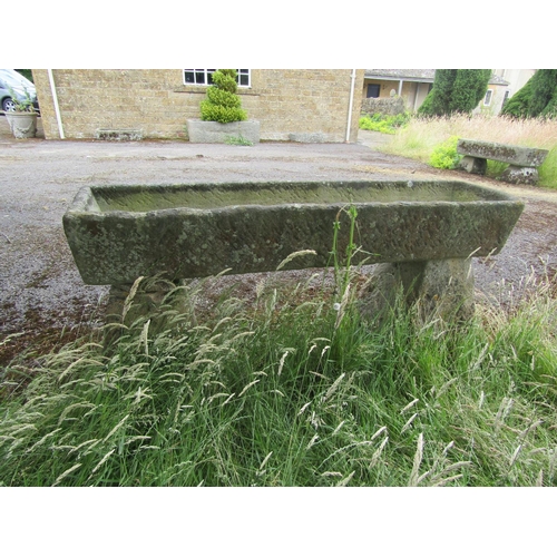 1060 - A large weathered natural stone planter / trough of rectangular form, raised on a pair of associated... 