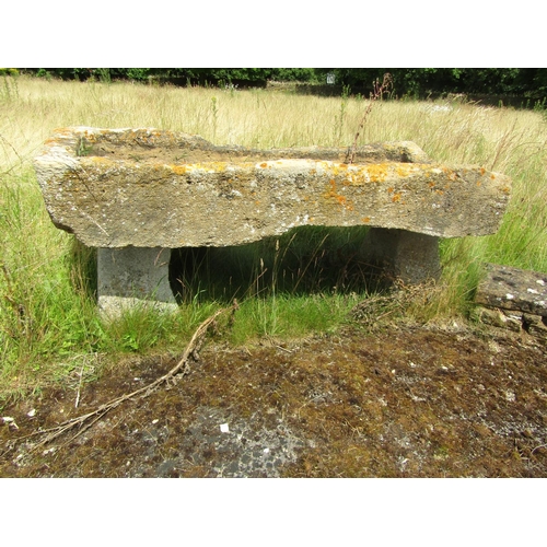 1067 - A heavily weathered / gnarled natural stone planter / trough of rectangular form, raised on an assoc... 