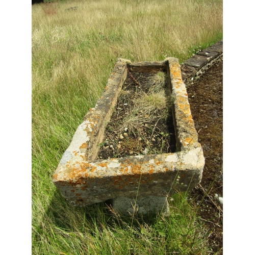 1067 - A heavily weathered / gnarled natural stone planter / trough of rectangular form, raised on an assoc... 