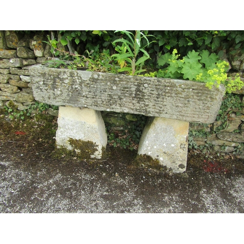 1070 - A weathered natural stone planter / trough of rectangular form, raised on a pair of assorted tall st... 