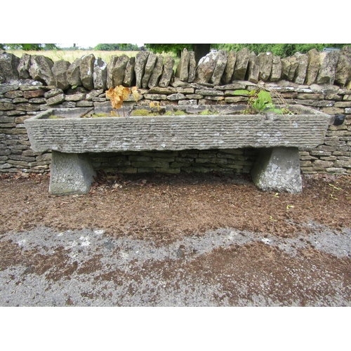 1072 - A long weathered natural stone planter / trough of rectangular form, with combed finish, divided by ... 