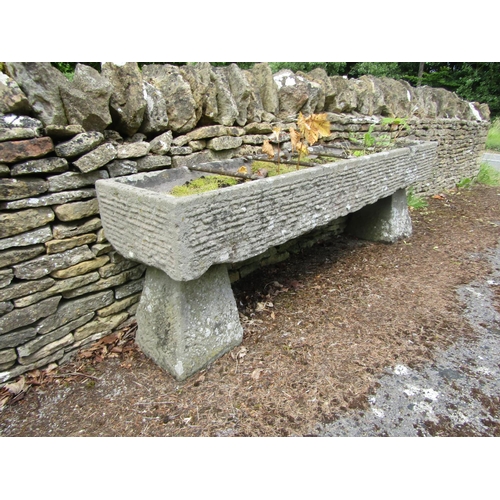 1072 - A long weathered natural stone planter / trough of rectangular form, with combed finish, divided by ... 