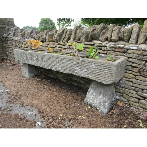 1072 - A long weathered natural stone planter / trough of rectangular form, with combed finish, divided by ... 