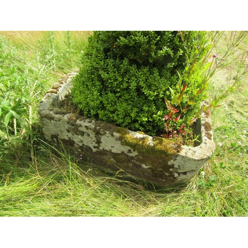 1076 - A large weathered natural stone planter of rounded squared form, with a well established box topiary... 