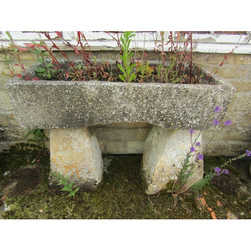 1087 - A weathered natural stone planter / trough of rectangular form (with losses) raised on a tall associ... 