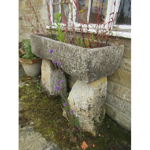 1087 - A weathered natural stone planter / trough of rectangular form (with losses) raised on a tall associ... 