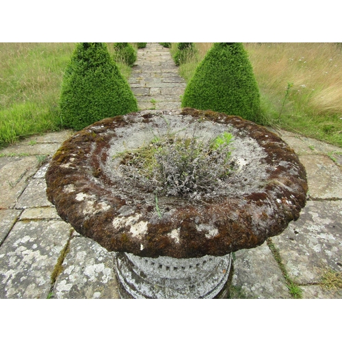 1089 - A well weathered composition stone garden planter of tapering cylindrical form, with flared rim and ... 