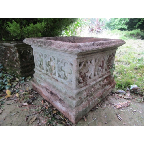 1091 - A pair of weathered carved composition stone planters of squared form with moulded lozenge borders, ... 