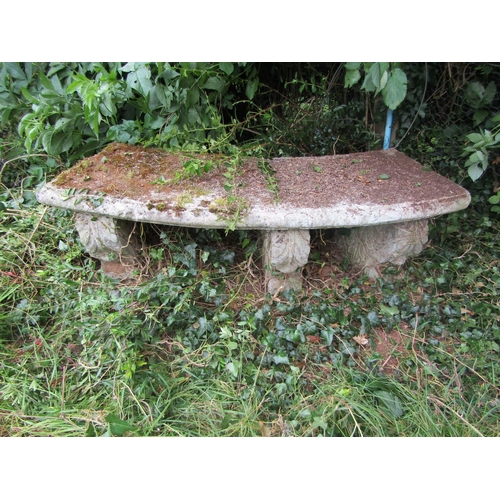 1094 - A weathered composition stone bench with curved seat and moulded supports, 38cm high, 133cm wide. 

... 