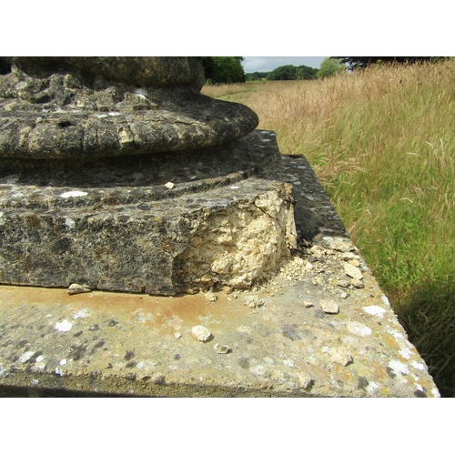 1097 - A monumental pair of 19th century weathered composition stone garden urns, raised on associated plin... 