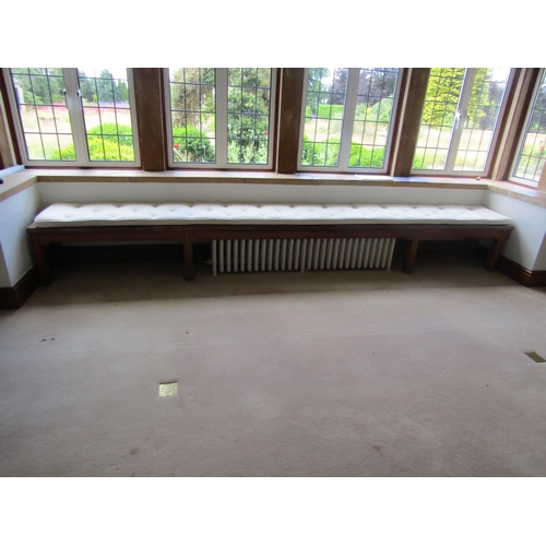 1104 - A long bespoke-made oak window bench, loosely in the ecclesiastical / arts and crafts style, with as... 