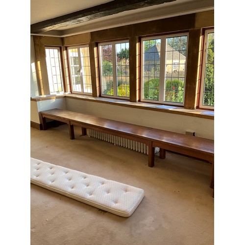 1104 - A long bespoke-made oak window bench, loosely in the ecclesiastical / arts and crafts style, with as... 