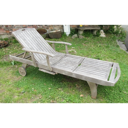 1178 - A Bramblecrest weathered (silvered) teak two wheeled garden sun lounger with adjustable slated seat ... 