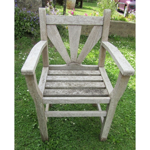 1179 - A pair of Gloster teak garden chairs with open arms and slatted detail together with a acompaning st... 