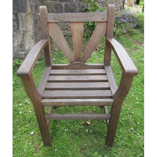 1179 - A pair of Gloster teak garden chairs with open arms and slatted detail together with a acompaning st... 