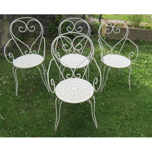 1180 - A set of four painted ironwork garden chairs with open scroll and pierced detail