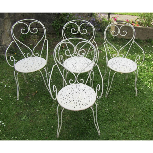 1180 - A set of four painted ironwork garden chairs with open scroll and pierced detail