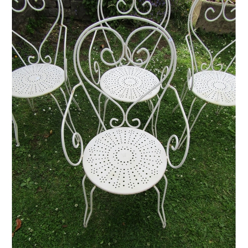 1180 - A set of four painted ironwork garden chairs with open scroll and pierced detail