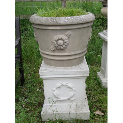 1171 - A weathered cast composition stone garden planter of circular tapered and ribbed form with raised fl... 