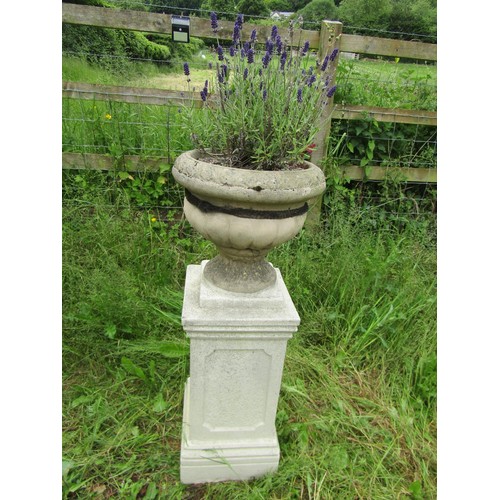 1172 - A painted and weathered cast composition stone garden urn, the circular lobed body set on a square s... 