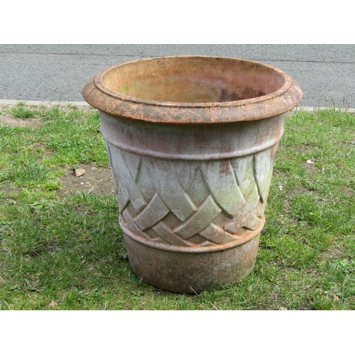 1268A - A large weathered terracotta planter of tapering circular form with moulded lattice detail, 55cm hig... 