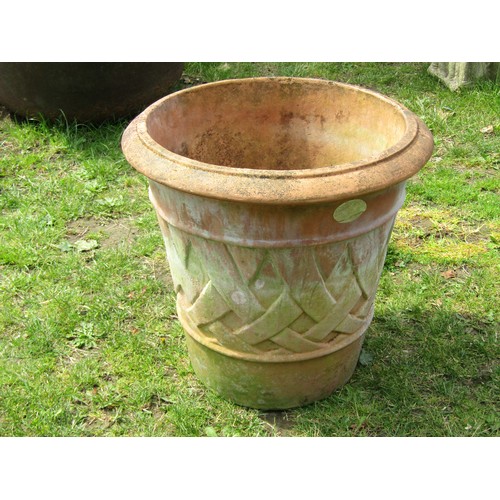 1268A - A large weathered terracotta planter of tapering circular form with moulded lattice detail, 55cm hig... 