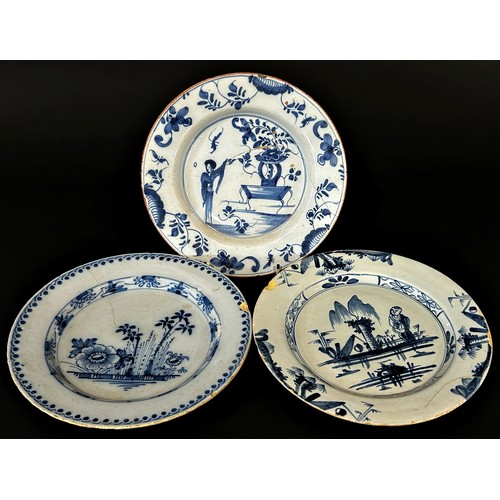 30 - Three 18th century tin glazed plates, two with chinoiserie detail, the third with floral panel, prob... 