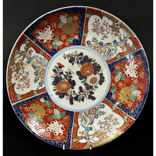 75 - A 19th century Japanese Imari charger with alternating bird and floral detail, 40cm diameter