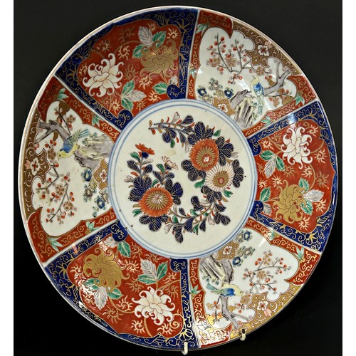 75 - A 19th century Japanese Imari charger with alternating bird and floral detail, 40cm diameter