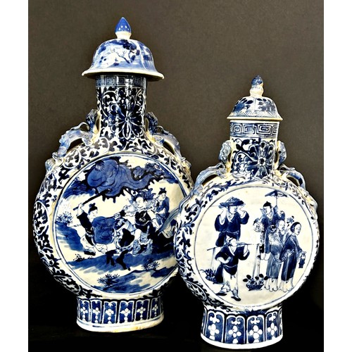 78 - Two Chinese blue and white moon flasks of graduated size, with character and foliate detail, 26cm hi... 